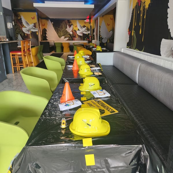 a long table with yellow and green chairs