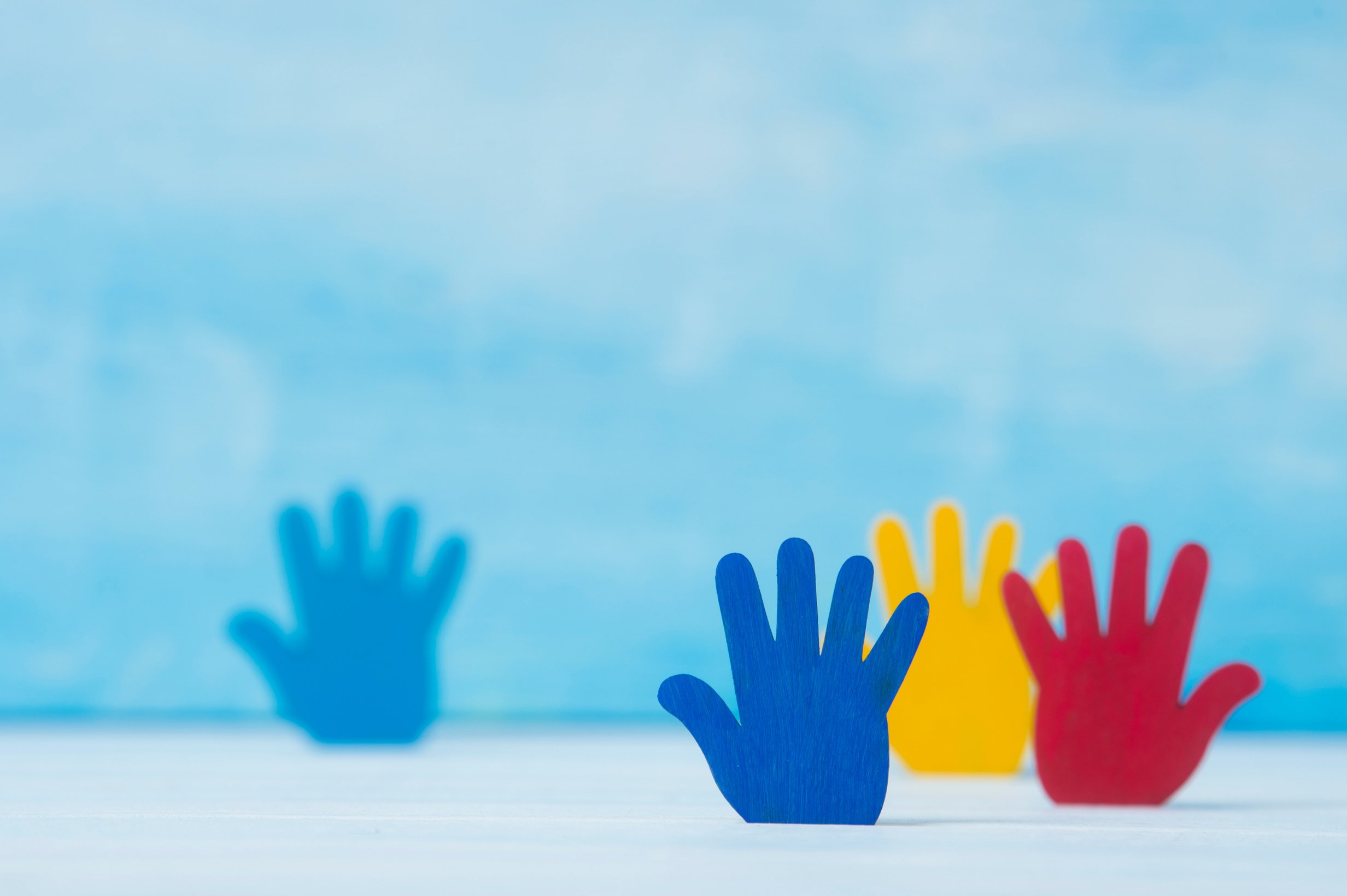 Colorful Hands on Blue Background